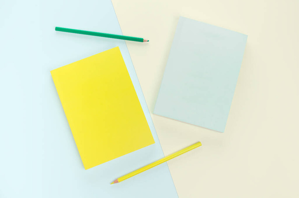 flat lay book and pencil stationery on green yellow background - Foto, Bild