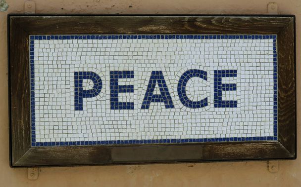 A peace mosaic writing with old ancient greek tiles. - Фото, изображение