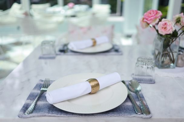 The wedding decor. Tables set for an event party or wedding reception. luxury elegant table setting dinner in a restaurant. glasses and dishes. hall for banquets and weddings - Photo, Image
