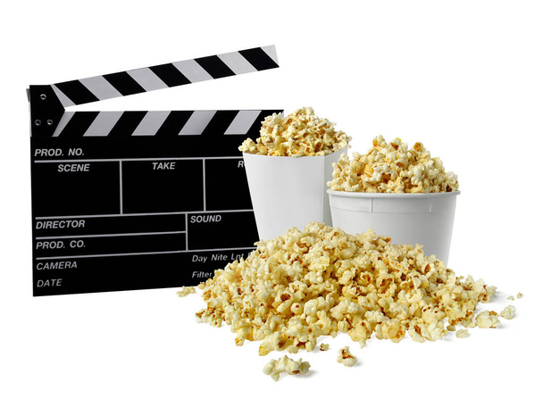 Movie clapperboard and popcorn isolated on white - Photo, image
