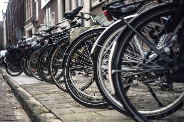 Bicycles parked on the street in Amsterdam - Φωτογραφία, εικόνα
