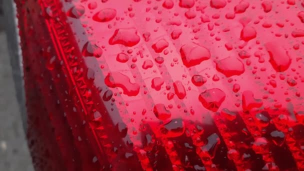 Car taillight covered with large drops of water during sleet - Footage, Video