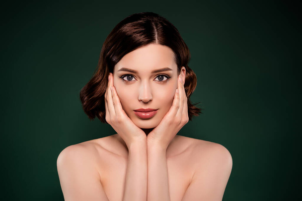 Portrait of good looking stunning woman touch cheeks pampering apple cream toner isolated on green color background - Foto, Imagem