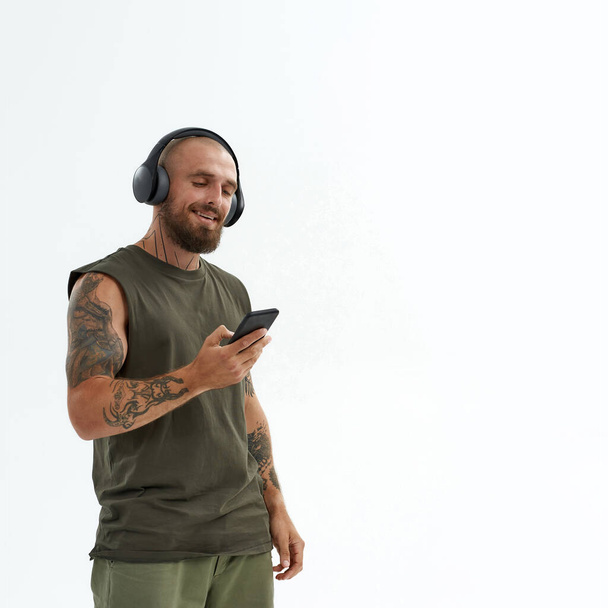 Young man listen music in earphones on smartphone - Photo, image