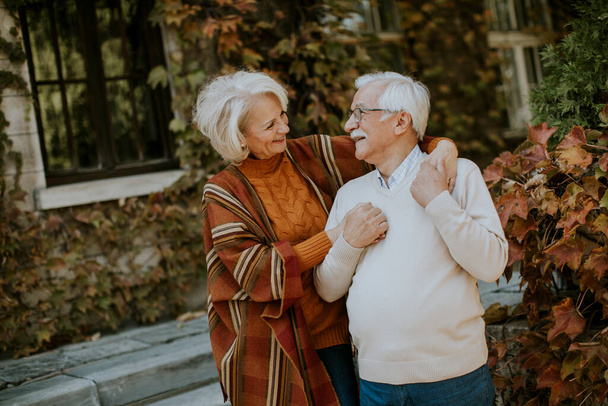 Hermosa pareja de ancianos abrazándose en el parque de otoño - Foto, Imagen
