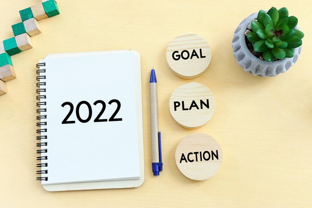 Top view image of note with the text 2022 and the words - goal plan action - Foto, Bild