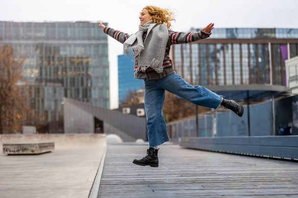 Happy young woman jumping in the city  - Valokuva, kuva