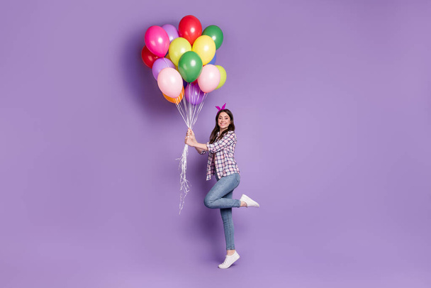 Full length body size photo cheerful happy girl keeping colorful balloons celebrating birthday isolated vivid violetcolor background - Fotoğraf, Görsel