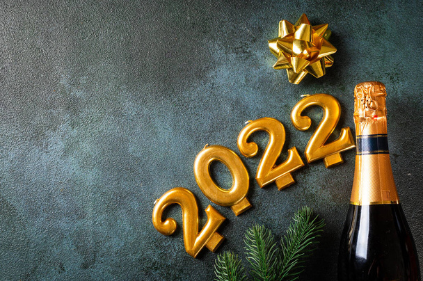 2022 numbers with champagne bottle and decor. Happy new year and festive concept. Top horizontal view copyspace. New Year Flatly. Christmas flatlay. New year 2022. New year concept - Photo, Image