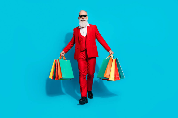 Full length body size photo aged man keeping packages after shopping isolated bright blue color background - 写真・画像