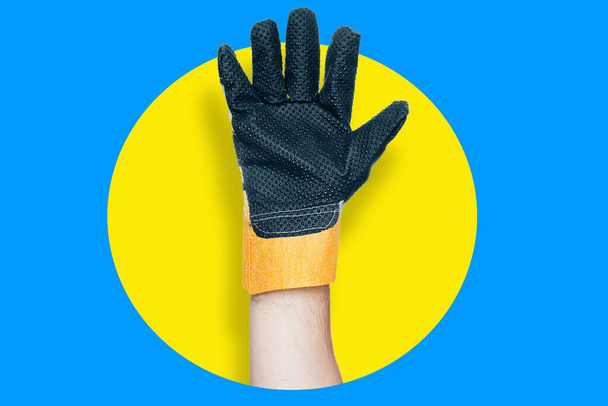 Open palm in construction glove. Bright advertising background. Attracts attention. Hand with spumped fingers - Photo, Image