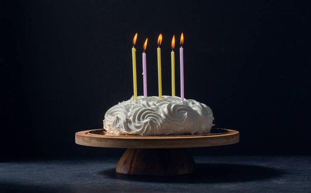 close up of zephyr cake with five candles burning - Fotoğraf, Görsel