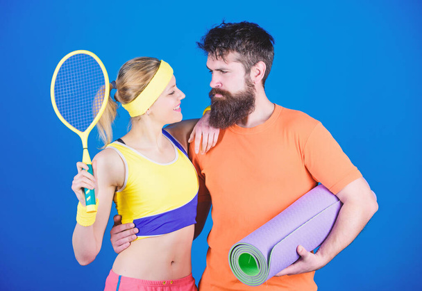 For the love of the Game. Athletic Success. Sport equipment. Sporty couple training with fitness mat and tennis racket. woman and bearded man workout in gym. Strong muscles and body. couple in love - Foto, Imagem
