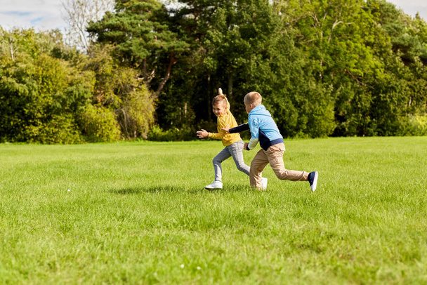 two happy boys playing tag game at park - Foto, Bild