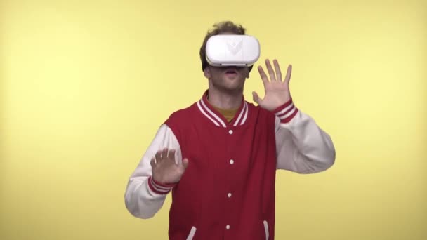 VR kulaklıklı korkmuş adam sarıya işaret ediyor. - Video, Çekim