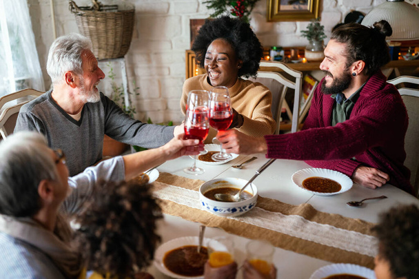 Happy multiethnic multigeneration family having fun together around kitchen table. People holiday food love happiness concept - Φωτογραφία, εικόνα