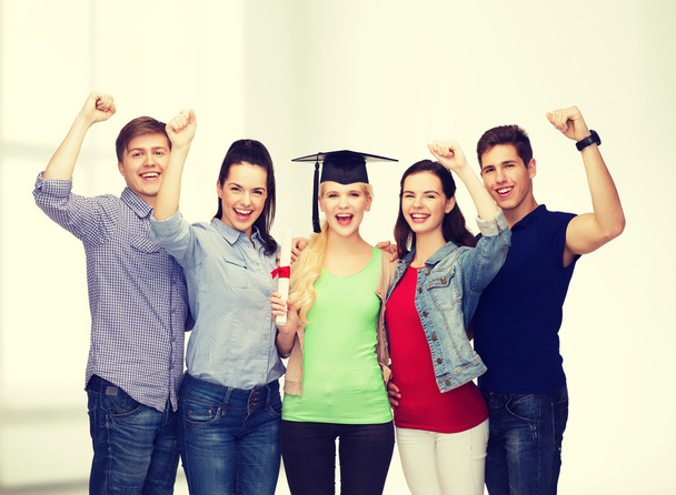 group of standing smiling students with diploma - Foto, Bild