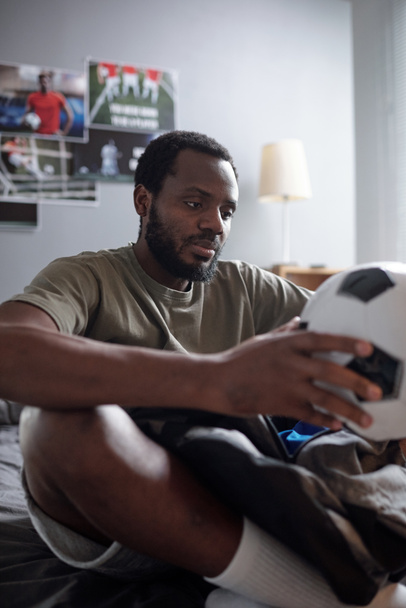 Contemporary football player holding soccer ball - Valokuva, kuva