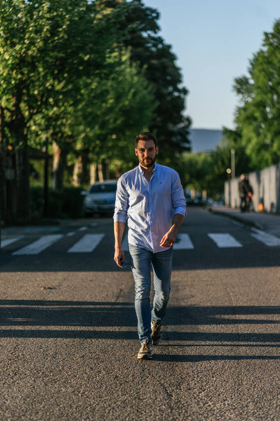 A col and attractive Slovenian man walking on the street - Foto, afbeelding