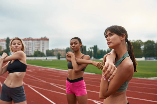 Women stretching before run training on treadmill - Fotó, kép