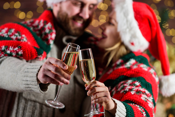 Drinks for adults. Home party. Sparkling wine glasses close up. Festive atmosphere. Couple in love enjoy christmas holiday celebration. Happy new year. Merry christmas. Celebrating christmas together - Photo, image