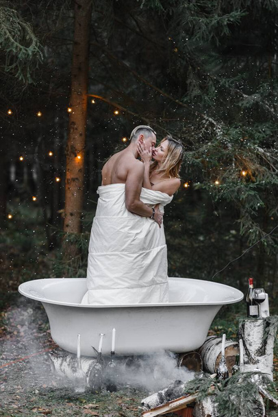 a couple of lovers in a bath in the forest passion love tenderness sexuality touching the spouse - Photo, Image
