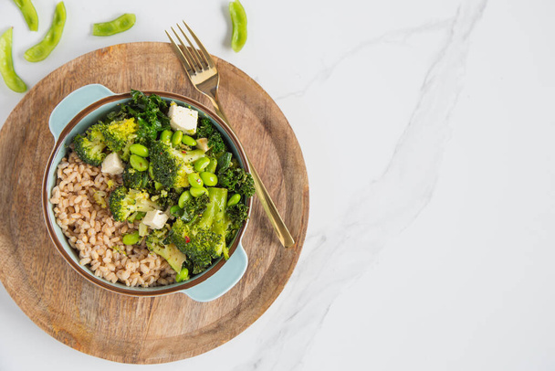 Vegan detox, green Buddha bowl with barley, edamame, kale, broccoli and tofu. Copy space. - Fotografie, Obrázek