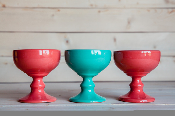 ice-cream bowls in red and blue on a wooden background - 写真・画像