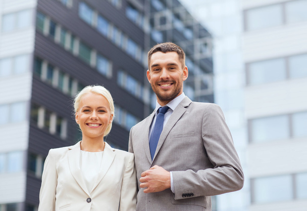 smiling businessmen standing over office building - Fotografie, Obrázek