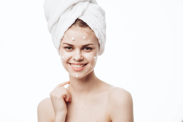 cheerful woman with a white towel on her head face cream skin care - Φωτογραφία, εικόνα