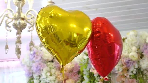 Κίτρινο και κόκκινο μπαλόνι σε σχήμα καρδιάς. Διακόσμηση συμποσίου - Πλάνα, βίντεο