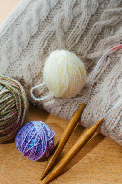 Knitting needles, colorful threads. Knitting background. Knitting yarn for winter handmade clothes - Fotó, kép