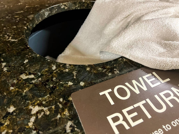 A used white towel on a granite towel return. - Photo, Image