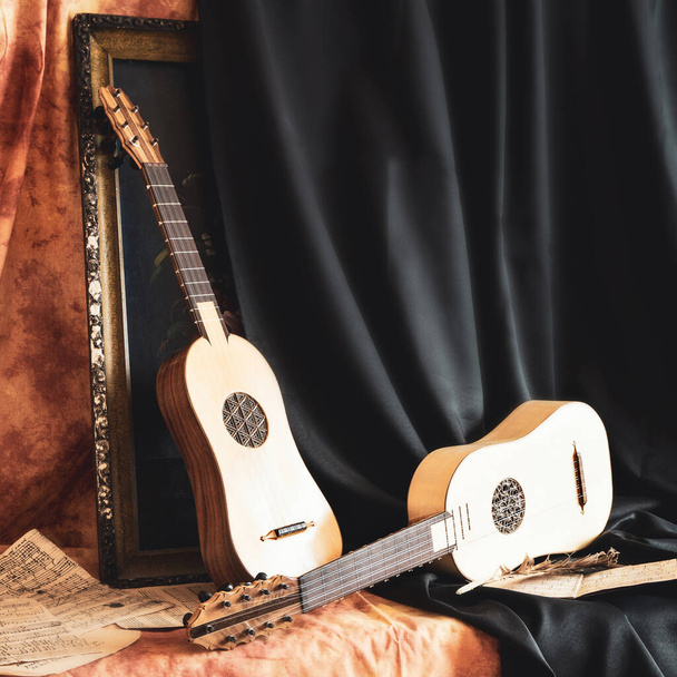 Musical still life in the Renaissance style with two renaissance guitars - Photo, Image