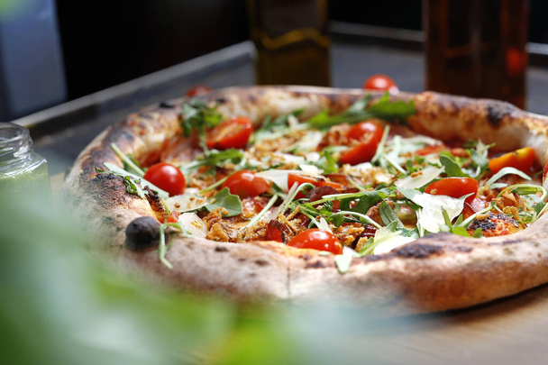 Pizza with tomatoes and arugula.Proposal for dishes..Culinary photography. Suggestion to serve the dish. - Photo, Image