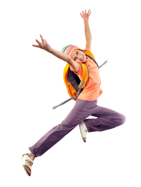 schoolgirl with backpack and a cap jumping - Foto, Bild
