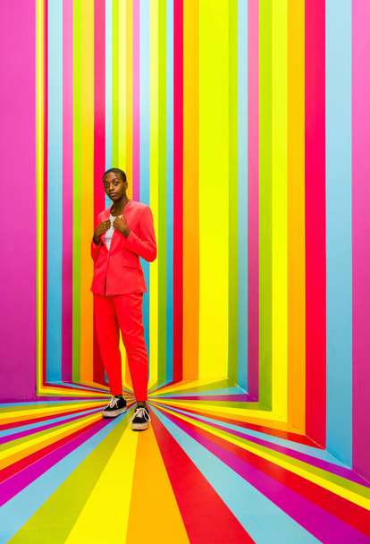 Beautiful african american young woman dancer having fun inside a rainbow box room - Cool and stylish afro adult woman portrait on multicolored background, influencer creating content for social networks in a selfie room - Zdjęcie, obraz