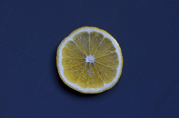 lemon sliced into rings on a dark blue background - Photo, image