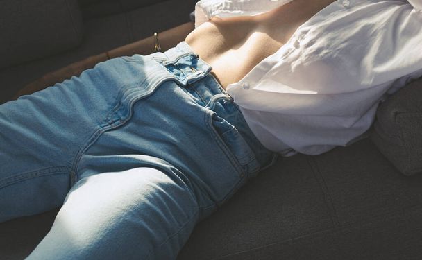 Fashionable girl in stylish blue jeans - Фото, изображение