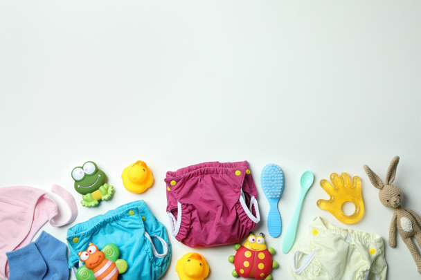 Concept of baby clothes with reusable diapers on white background - Photo, Image