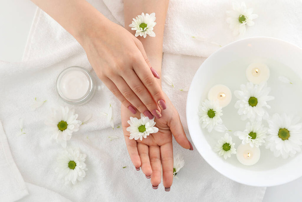 Concept of hand care with cosmetics on white towel background - Photo, Image
