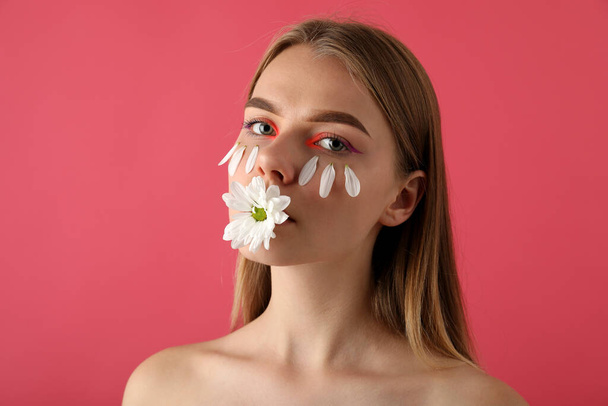 Beautiful model girl with flower on pink background - Valokuva, kuva