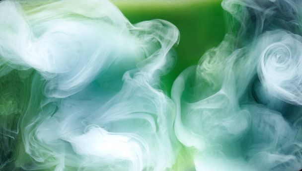 Green smoke on black ink background, colorful fog, abstract swirling emerald ocean sea, acrylic paint pigment underwater - Photo, image