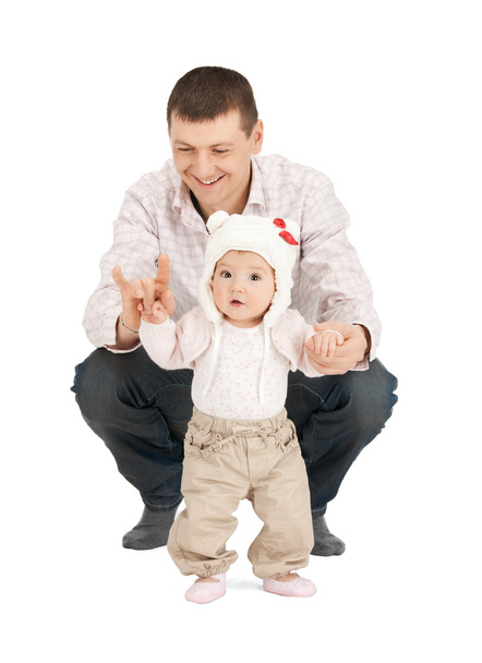 Baby making first steps with father help - Foto, imagen