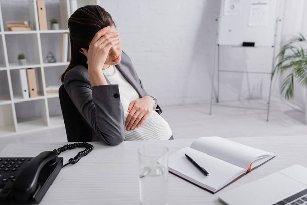 pregnant businesswoman in suit feeling unwell in office  - Photo, image