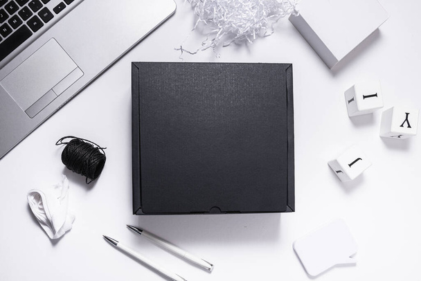 Black carton cardboard box top view, on office desk - Photo, Image