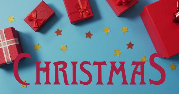 Image of christmas text over stars and presents. christmas, winter, tradition and celebration concept digitally generated image. - Foto, immagini