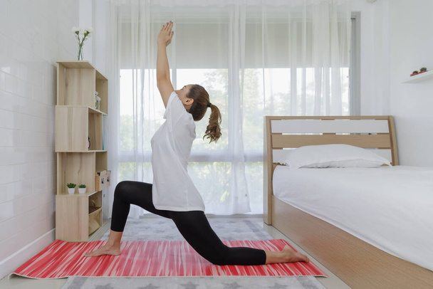 thai women playing yoga in bedroom stay at home concept  - Foto, Imagem
