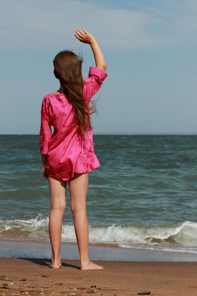 Little beautiful girl enjoy her life under the sun over sea beach, East Crimea - 写真・画像