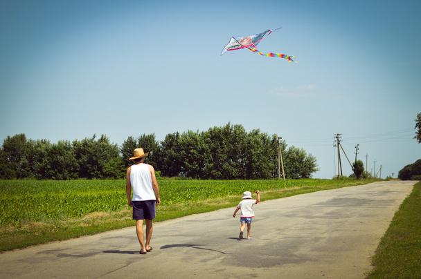 Father and son playing with kite outdoors - Foto, Imagen